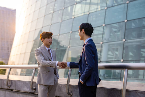 Two businessmen are shaking hands stock photo