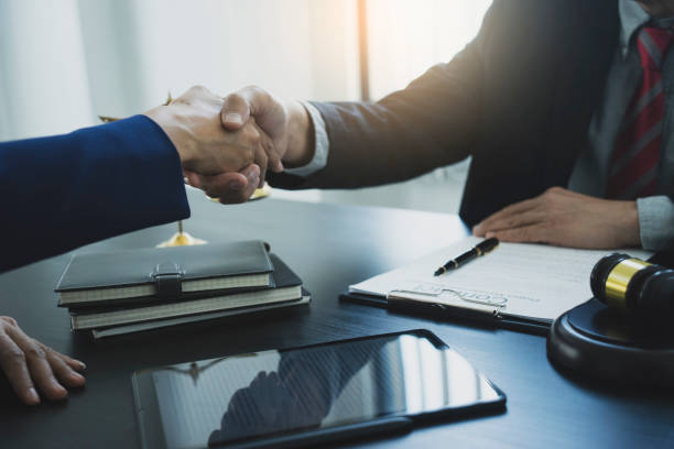Two businessmen are shaking hands to congratulate a contract stock photo