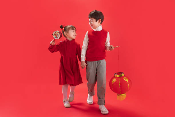 Two children with red lanterns stock photo