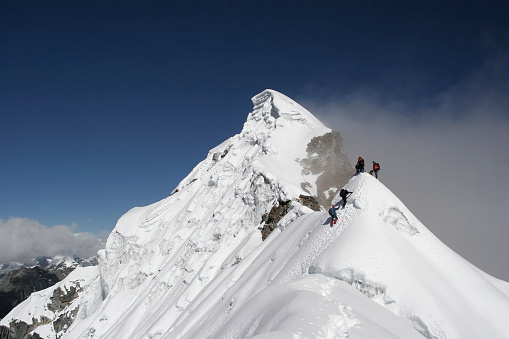 Climbers moving onto a subsidiary peak of a very large mountain. This is Lobuche East, the most difficult of the 
