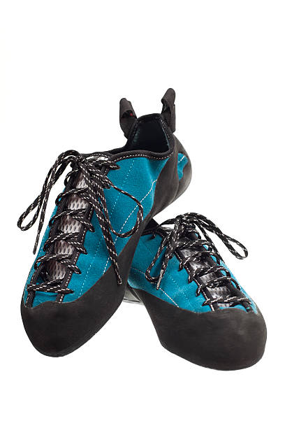 Two climbing shoes propped against each other stock photo