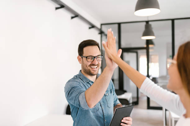 Two colleagues high-five. Two colleagues high-five. high five stock pictures, royalty-free photos & images