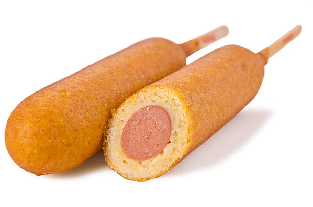 Two corn dogs with one cut in half stock photo
