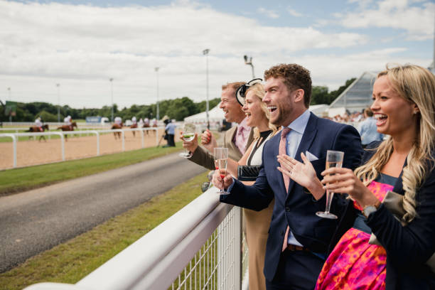 Two Couples Enjoying a Drink Couples enjoying a day at the races. Two couples enjoying a drink at the races. high society stock pictures, royalty-free photos & images