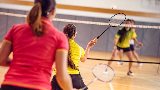 Two Couples Playing Badminton Stock Photo - Download Image Now - iStock