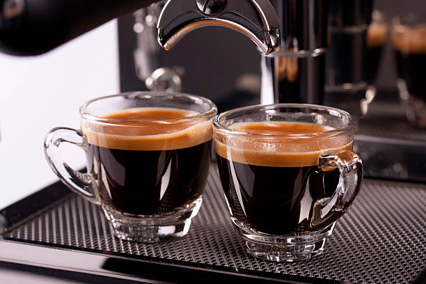 two cups of espresso shot with crema - espresso stockfoto's en -beelden