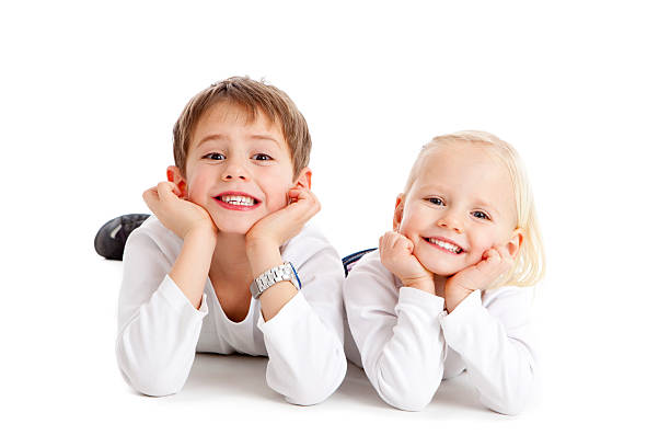 Two cute children grin stock photo