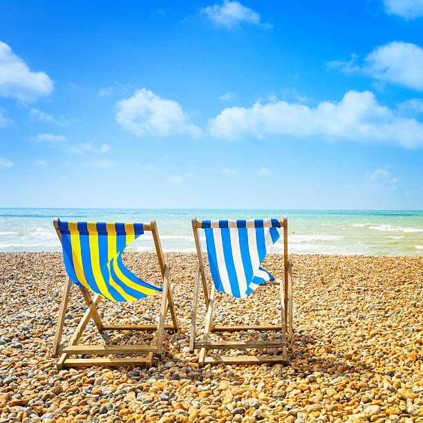 Two Deckchair in Brighton Beach at Summer Deckchair in Brighton beach at summer english channel photos stock pictures, royalty-free photos & images