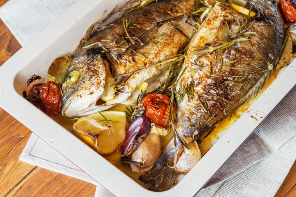 Two delicious whole baked fish. stock photo