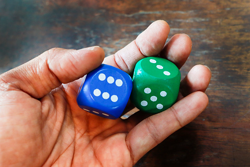 Two dice in the hand that is about to roll.