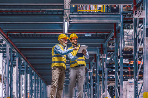 Two employees with tablet at logistics center warehouse stock photo