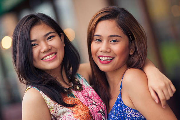 Two friends portrait Portrait of two happy young women outdoors. philippines girl stock pictures, royalty-free photos & images