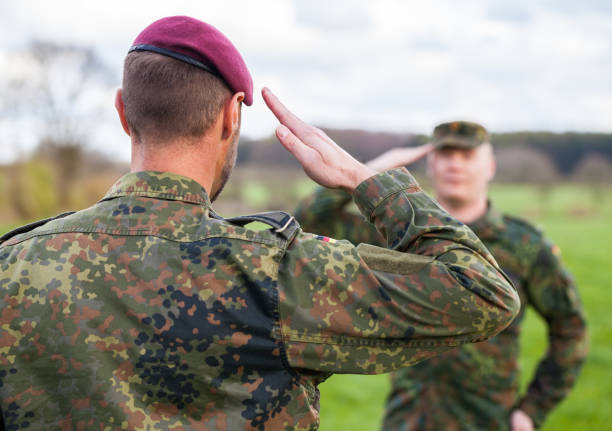 two german soldiers salute each other stock photo