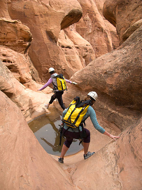 Two girls canyoneering in Utah. stock photo