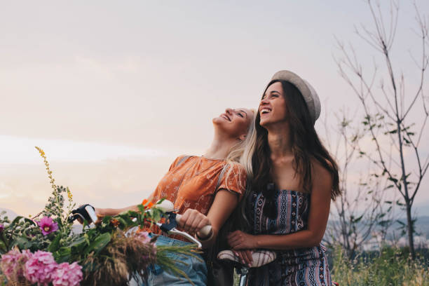 Two girls enjoy bike and great day stock photo