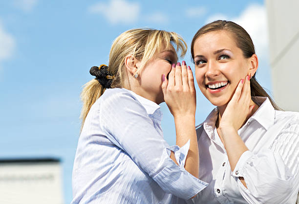 Two Girls Gossiping stock photo