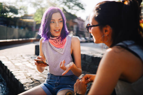 Two girls having a discussion in the street stock photo