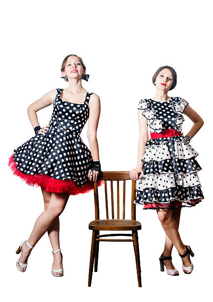 Two Girls Posing Standing Leaning On A Chair Stock Photo More