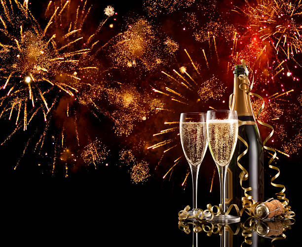 Two glasses and a bottle of champagne on New Years Eve stock photo