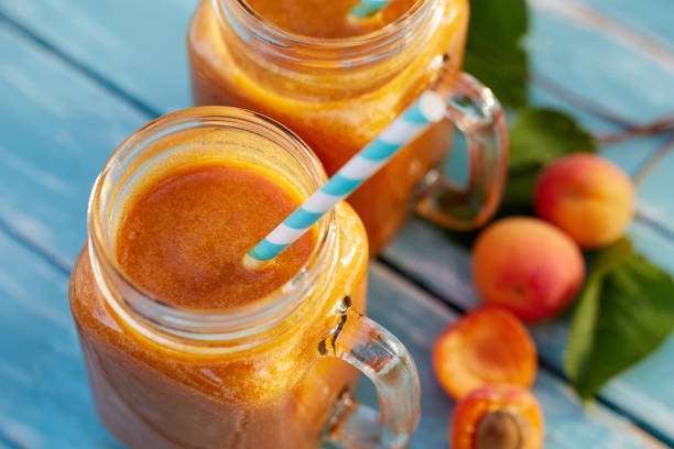 Two glasses of fresh apricot smoothie Top view of two glasses of fresh apricot smoothie peach smoothie stock pictures, royalty-free photos & images