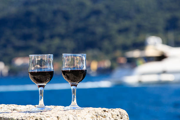Two glasses of red wine against the sea, summer vacation