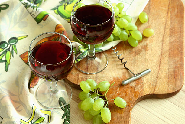 Two glasses of red wine and ripe grapes.. stock photo