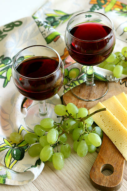 Two glasses of red wine and ripe grapes.. stock photo
