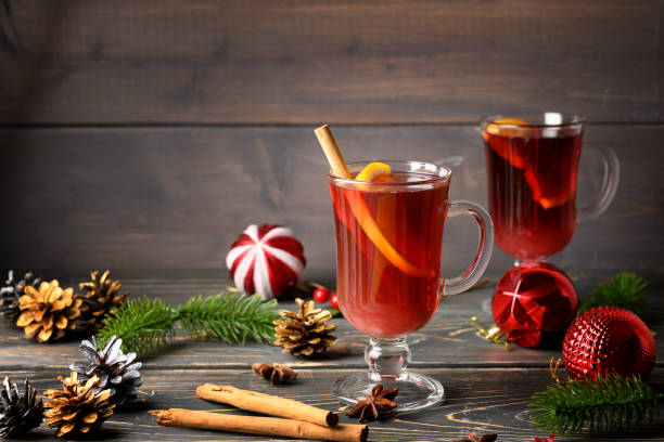 Two glasses with festive mulled wine, orange and cinnamon. Christmas and New Year atmosphere. Warm, cozy photo stock photo