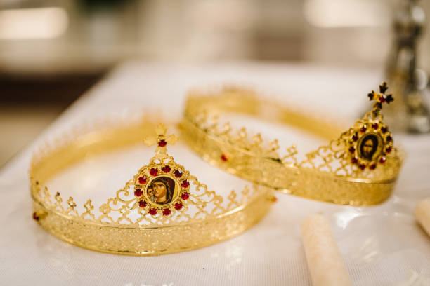 Two golden crown with red gemstones on altar in church. traditional wedding ceremony, space for text. religion. Close up. stock photo