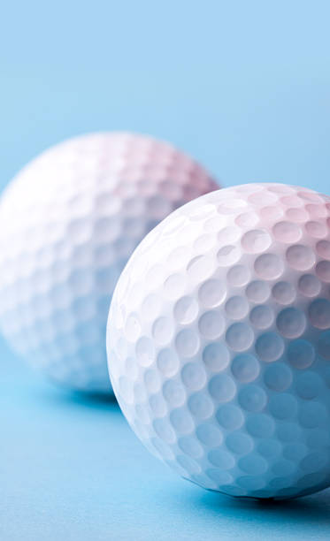 Two Golf Balls on Blue stock photo
