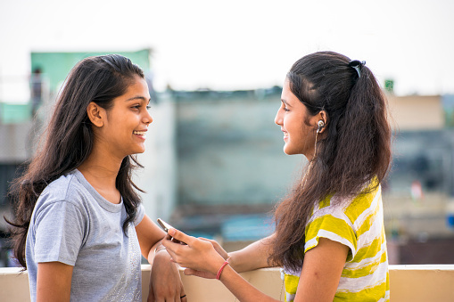 Two Happy Friends Having A Casual Conversation Stock Photo
