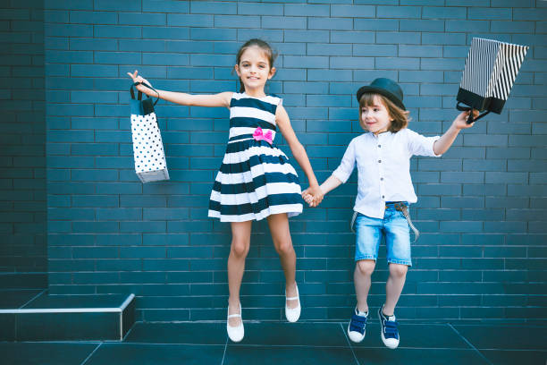 two-happy-kids-carrying-shopping-bags-picture-id1166199191?k=20&m=1166199191&s=612x612&w=0&h=whJPiA2-wTpq85nuXaN55J3d1YFdo1ozTXJrDAyehig=