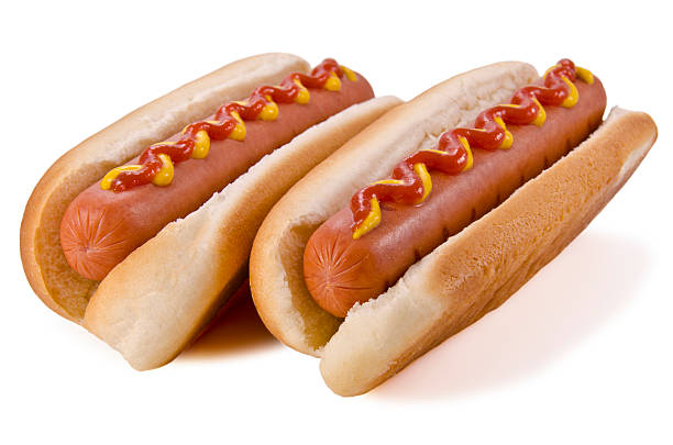 Two hot dogs with ketchup and mustard on top Two hot dogs on a white background hot dog stock pictures, royalty-free photos & images