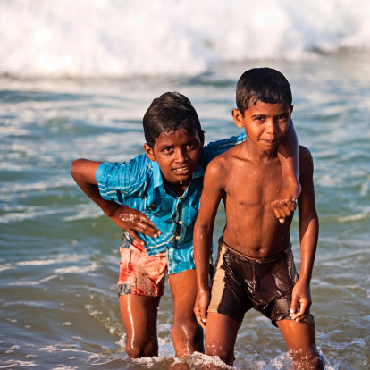 Two Indian Boys On The Beach Stock Photo - Download Image Now - iStock