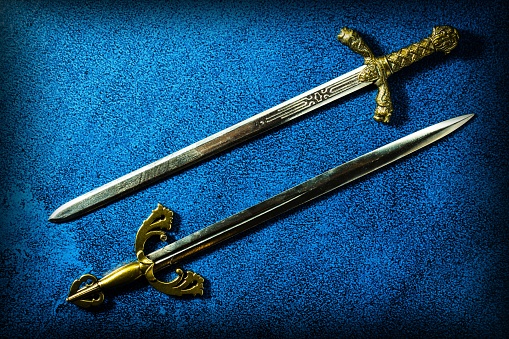 https://media.istockphoto.com/photos/two-knightly-swords-lie-in-parallel-on-a-dark-blue-background-view-picture-id1193919063?k=6&m=1193919063&s=170667a&w=0&h=6bXFvP_Tm0okBTtYrPx06cGy0lzrwxBHGEtKjxQYezU=