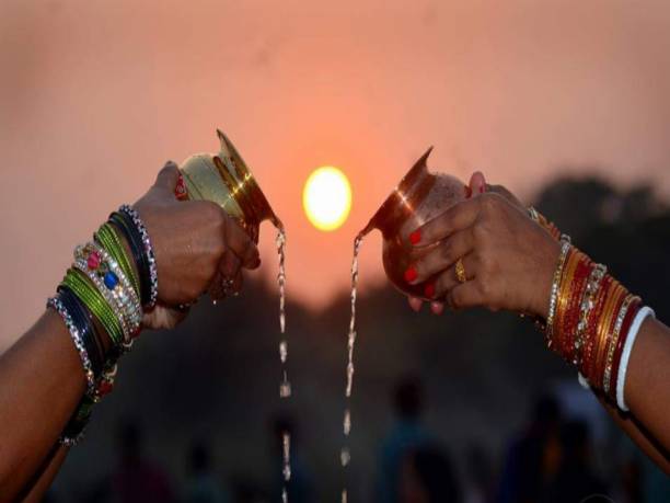 Two lady Watering the sun worshipped surya sun god arghyachath puja indian culture This is how two lady Watering the sun worshipped surya sun god it the indian culture it is also known as chhath puja in hindu culture. chhath stock pictures, royalty-free photos & images