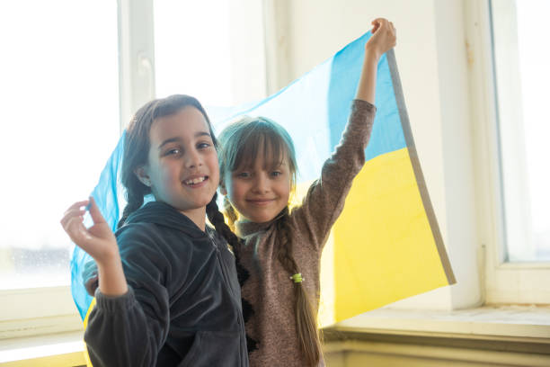 two little girls with ukraine flag stock photo