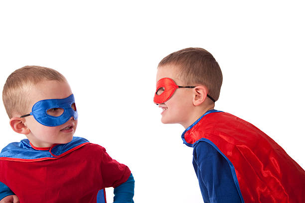 Two Little Heros Teasing Each Other stock photo