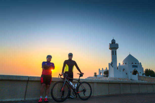 Two male cyclist Silhouette in Khobar Corniche Saudi Arabia. stock photo