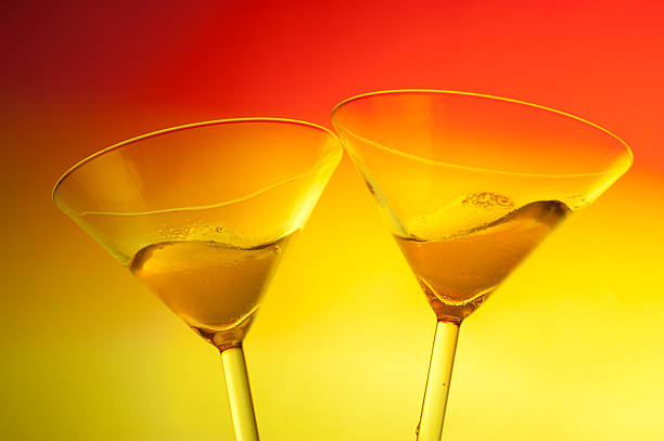 Two Martini toast Two Martini toast on warm background dirty martini stock pictures, royalty-free photos & images