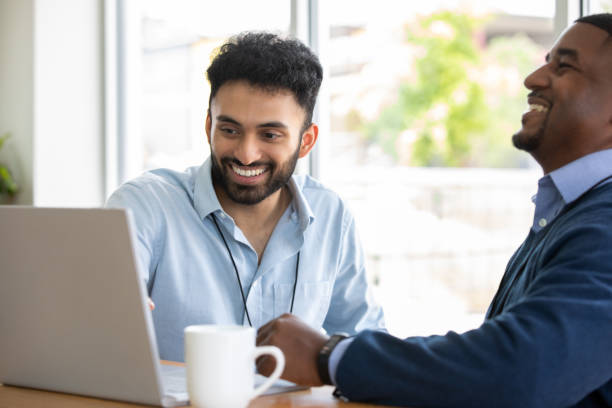 Two Men looking at laptop in meeting stock photo