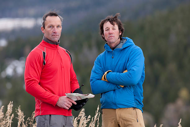 Two Men Standing in the Wilderness With a Map stock photo