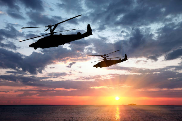 Two military helicopter Two military helicopter on a sunset background. air attack stock pictures, royalty-free photos & images