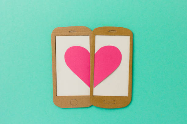 Two mobile phone screens combining a pink heart stock photo