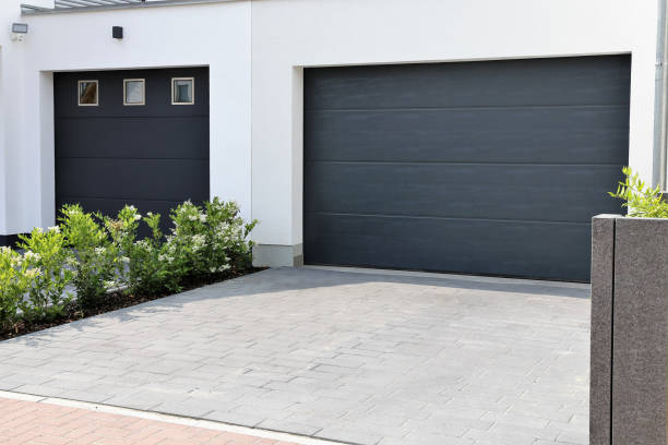 two modern new garage doors (sectional doors) in a residential district - door imagens e fotografias de stock