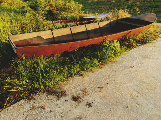 Two old boats on the river bank stock photo