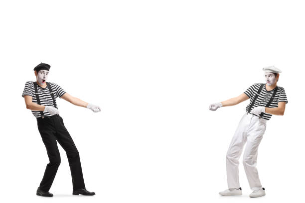 Two pantomime men pulling an imaginary rope Full length shot of two pantomime men pulling an imaginary rope isolated on white background mime artist stock pictures, royalty-free photos & images