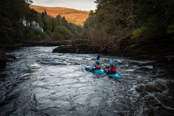 Two people kayaking on the River Dee, Wales stock photo
