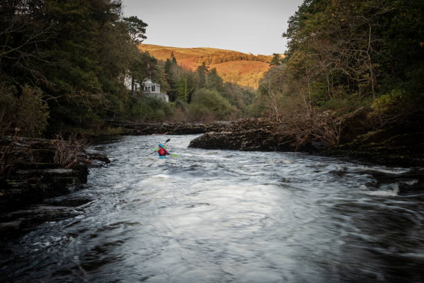Two people kayaking on the River Dee, Wales stock photo