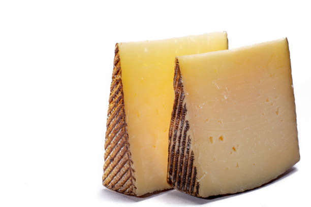 twee stukken van manchego, queso manchego, kaas gemaakt in de regio la mancha met een oppervlakte van spanje van de melk van schapen van het manchega ras, geïsoleerd op wit - manchego stockfoto's en -beelden
